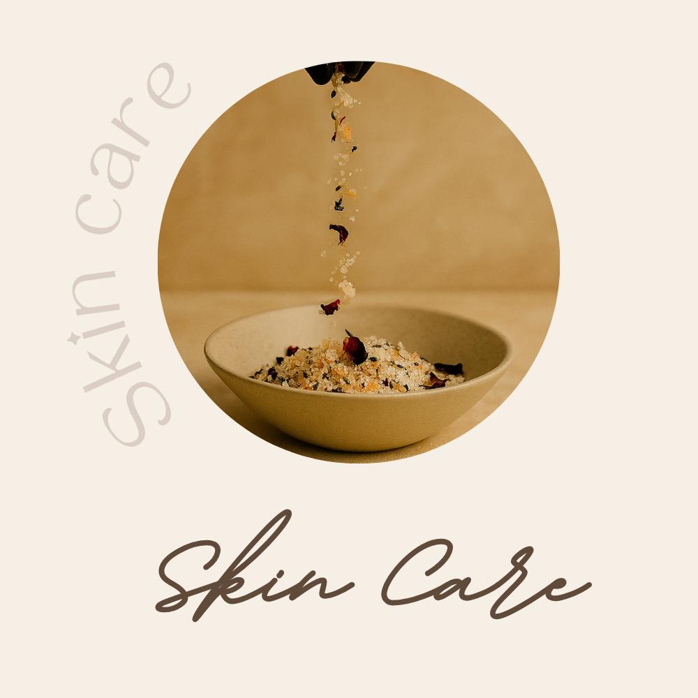 A women of afro caribbean decent with a white robe has placed body butter on her shoulder 